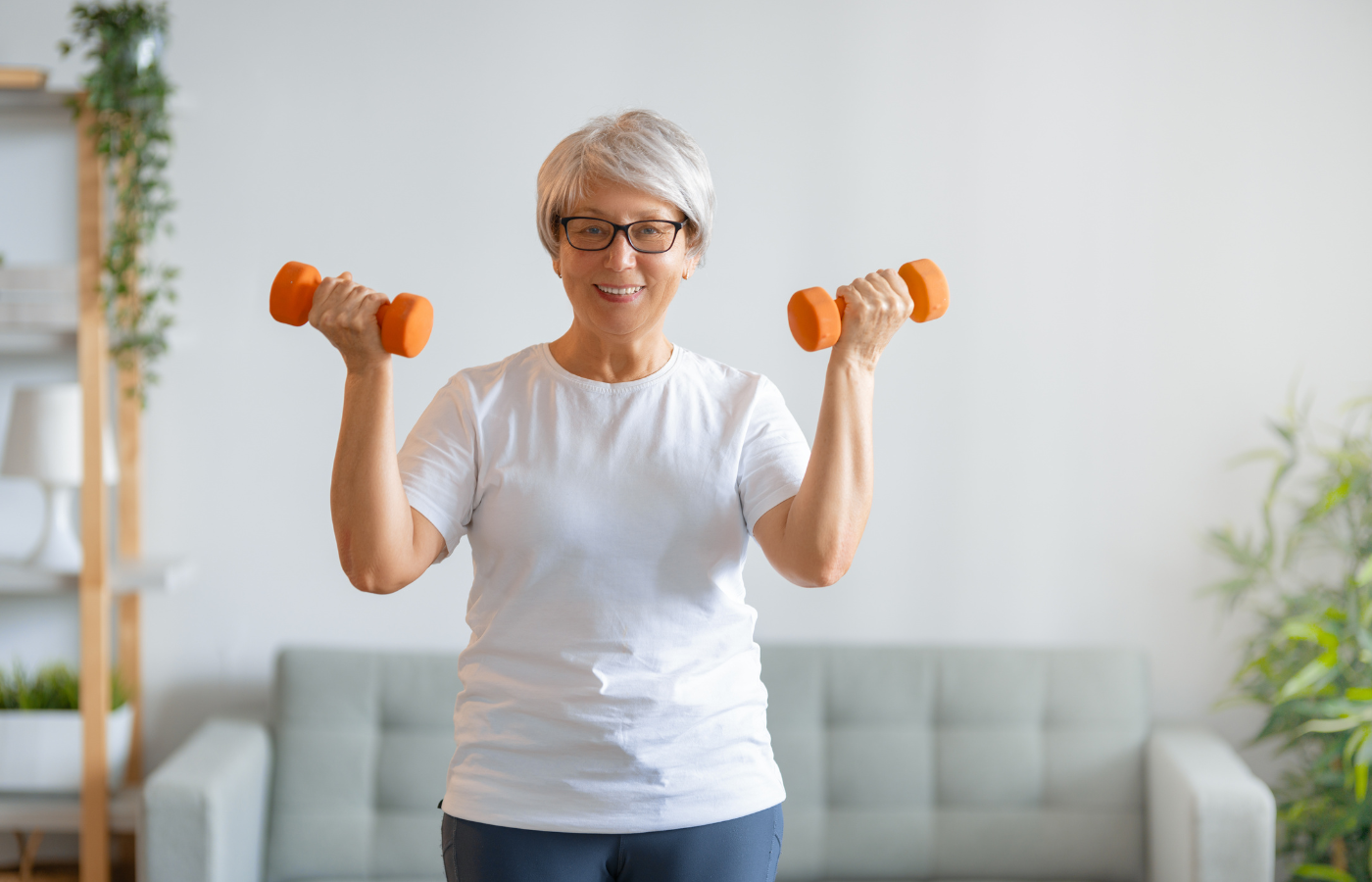An elderly woman working out with vinyl-dipped dumbbells
